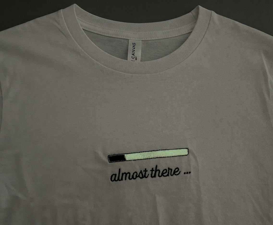Almost There Tee — Glow-in-the-Dark Embroidered Loading Bar